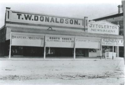 Black and White photograph.  T W Donaldson and J V Tolerton stores.  Massingham St Kellerberrin