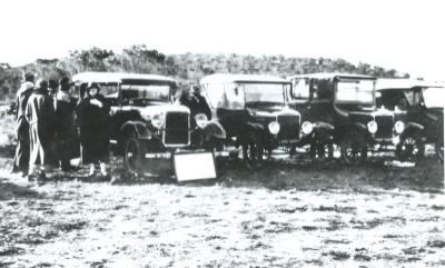 Black and White photograph.  Harmon's stand at Kellerberrin Show.  Studebaker and Ford cars