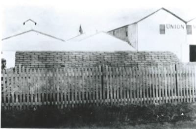 Black and White photograph.  Kellerberrin Flour Mill.  Bagged wheat stack