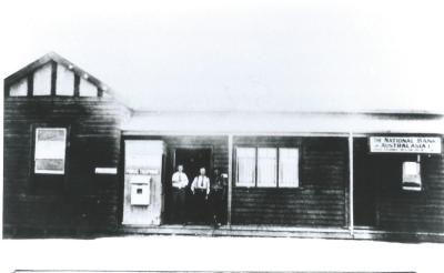 Black and White photograph.  National Australia Bank -Baandee.  3 men standing on verandah of National Australia Bank