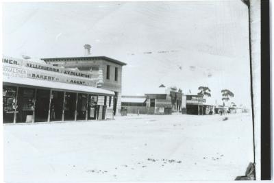 Black and White photograph.  Massingham Street, Kellerberrin.  Kellerberrin Bakery J V Tolerton - Newsagent, Commercial Bank, National Australia Bank