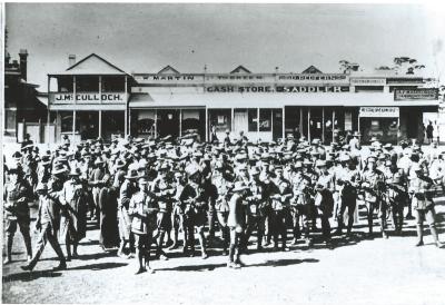 Black and White photograph.  Soldiers having morning tea, disembarking from train