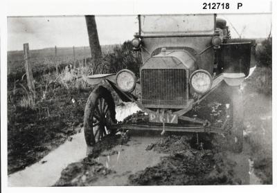 Black and White photograph.  Mr N Halls T Model Ford bogged on Main Road near Badgetopping