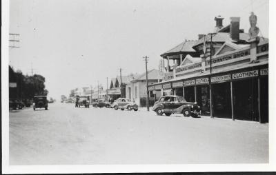 Black and White photograph.  Massingham Street facing East.  Stores in photo - Thornton Bros, Post Office, Bank of NSW, Kellerberrin Co-op