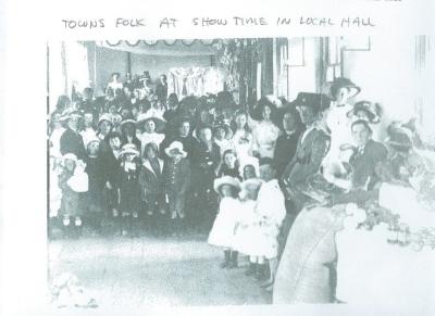 Copy of photograph. Black and White. Towns folk at show time in local hall