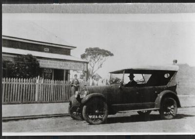 Black and White photograph.  House and Car Marchants Machinery Dealers.  East Massingham Street opposite Railway Crossing