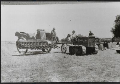 Black and White photograph.  Tractor and Header sold by Marchants
