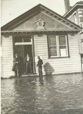 Bank of New South Wales.  Black and White photograph of Bank of New South Wales.  Floods 1917.  3 gentlemen standing in front of Bank