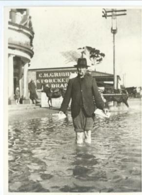 Black and White photograph showing gentleman collecting the mail during flood in 1917