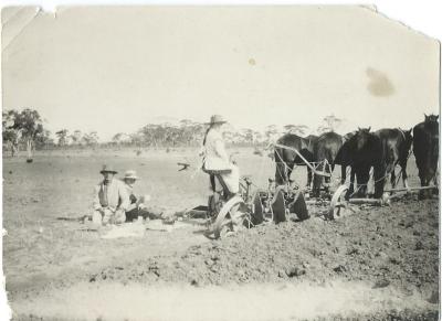 Black and White photograph.  Plough and horse team.  Lunch time with Father, Mother and Daughter on Plough