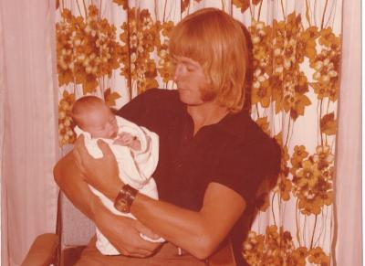 Colour photograph.  Mark Langford with baby Nicole Langford