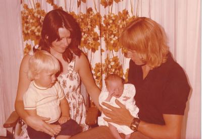 Colour photograph.  Judy and Mark  Langford with baby Nicole Langford and young boy (son?)