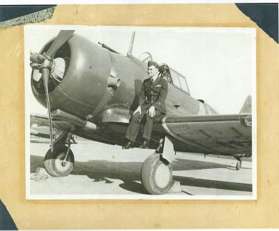 Black and White photograph.  Flying Officer Robert Kirkman, 21 Squadron Laverton, Victoria.  On eve of departure to Singapore July 1940.  Aircraft - C.A.c Wirraway