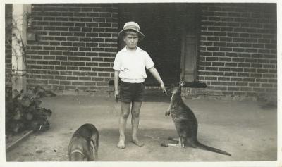 Black and White photograph.  Bill Nomnus with kangaroo and pet dog.  August 30 1932, his 7th Birthday