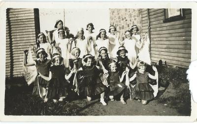 Black and White photograph.  Doodlakine Children's concert 1938 Back Row : Joan Nicholls, Mary Magson, Dorothy McLean, Verna Jennings Next Row: R Ward, Dora Evans, Daphne McLean, Peggy Dalton, Marjorie Jacques Next Row: D Mather, Joyce McLean, Norma Da...