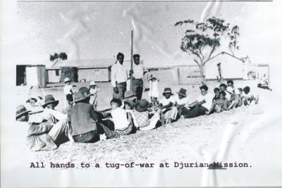 Black and White photograph.  Tug of war at Djurian Mission