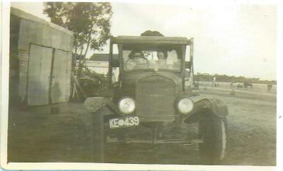 Black and White photograph.  Old Car with 2 women inside KE 439