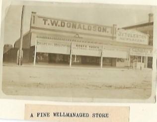 Black and white photograph T W Donaldson - Drapery & Millinery, Boots, Shoes - Clothing and Mercery Furniture and Furnishings TJ V Tolerton - Newsagency Kellerberrin 1924