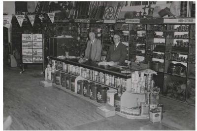 Black and White photograph.  Gus and Ray Carger in the mid-Massingham St premises, which is now the Community Resource Centre