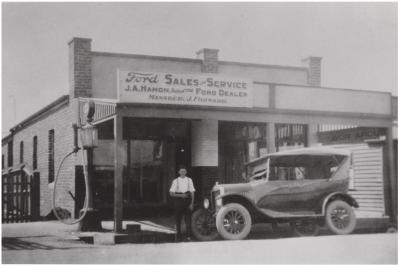 Black and White photograph Garage - J A Hamon, authorised Ford Dealer.  Manager J Forward.  Fuel Bowser outside.  Car out front