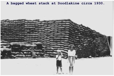 Black and white photograph.  A bagged wheat stack at Doodlakine circa 1930