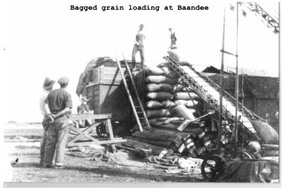 Black and White photograph.  Bagged  grain loading at Baandee