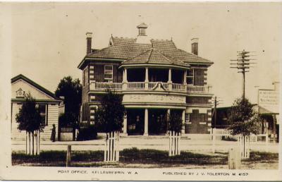 Black and White postcard, published by J V Tolerton.  Kellerberrin Post Office. Westralian Bank on the left and shop on the right. Planted trees in foreground