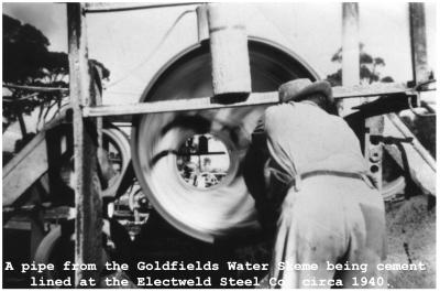 Black and White photograph.  A pipe  from the Goldfields Water Scheme being cement line at the Electweld Steel Co