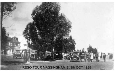 Black and White photograph.  Reso Tour Massingham Street, Kellerberrin.  Cars parked across the road with people milling around.  Post office in background