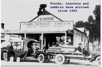 Black and White photograph Trucks, tractors and rabbits have arrived circa 1922 J A Hamon Ford Service Station, Massey Harris Agency
