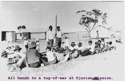 Black and White photograph "All hands to a tug of war at Djurian Mission"