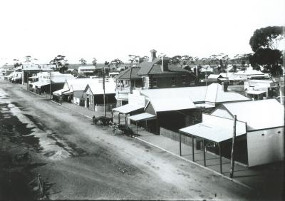 Black and white photograph.  Taken from Water Tower includes Post Office and McCabes store