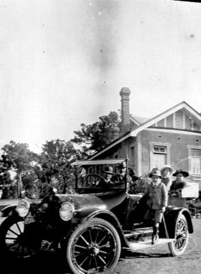 Don McCallum on car running-board.