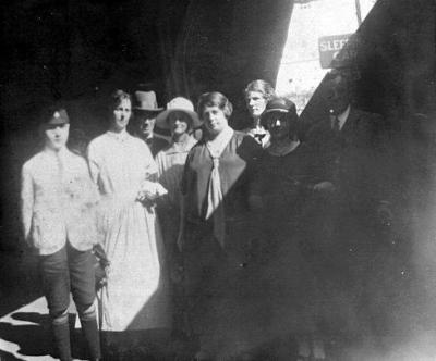 Group of people on railway platform.