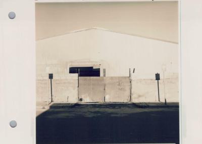 PHOTOGRAPH (PROOF SHEET): BUILDING BEHIND A FENCE, SONYA SEARS
