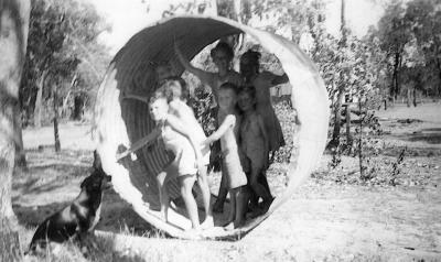 Wilkinson family children playing in old water tank Don, Neil, Nellie, Judy, Rodney, Steve & Marion Wilkinson