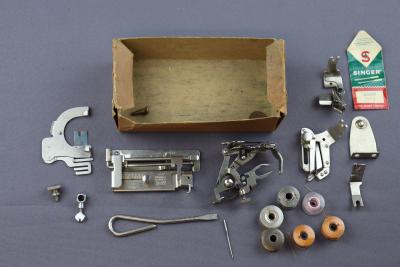 BOX OF SEWING MACHINE ATTACHMENTS AND TOOLS