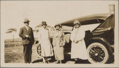 PHOTOGRAPH (DIGITAL COPY): FOUR ADULTS STANDING AT A CAR, WHITE FAMILY