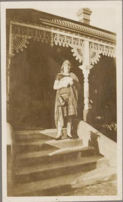 PHOTOGRAPH (DIGITAL COPY): WOMAN ON STEPS INFRONT OF HOUSE, WHITE FAMILY