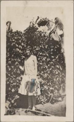 PHOTOGRAPH (DIGITAL COPY): WOMAN IN FRONT OF HEDGE, WHITE FAMILY