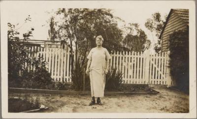 PHOTOGRAPH (DIGITAL COPY): MOTHER INFRONT OF A FENCE, WHITE FAMILY