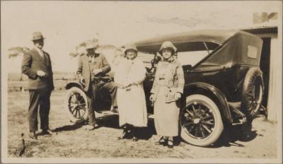 PHOTOGRAPH (DIGITAL COPY): FOUR ADULTS IN FRONT OF A CAR, WHITE FAMILY