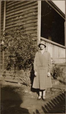 PHOTOGRAPH (DIGITAL): WOMAN STANDING OUTSIDE HOUSE, 1926, GERTRUD LIPFERT ALBUM 1927