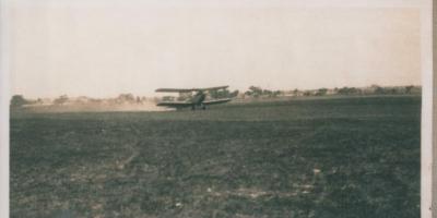 PHOTOGRAPH: BI-PLANE TIGER MOTH TAKING OFF IN PADDOCK