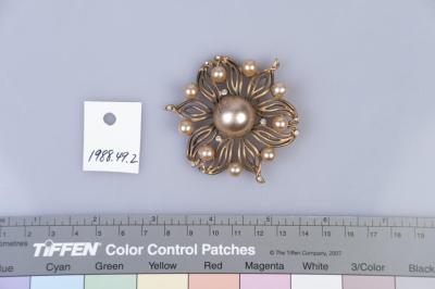 BROOCH: FLOWER SHAPED, METAL PETALS WITH PEARLS