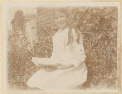 PHOTOGRAPH (DIGITAL COPY): CHILD READING, ABRAHAMS FAMILY