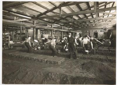 PHOTOGRAPH (COPY): METTERS' WORKMEN CASTING STOVE TOPS