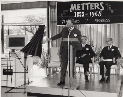 PHOTOGRAPH: PREMIER BRAND UNVEILING PLAQUE, 70TH ANNIVERSARY OF METTERS LTD, 1965