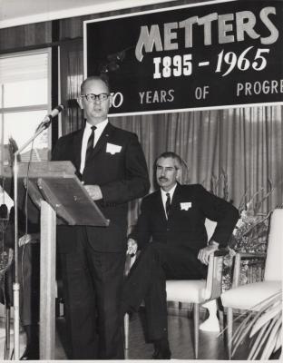 PHOTOGRAPH: WALLY HUGHES DELIVERING SPEECH, 70TH ANNIVERSARY OF METTERS LTD, 1965