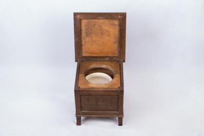 COMMODE: INSIDE TOILET WITH UPHOLSTERED SEAT